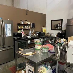 a kitchen area with a refrigerator, stove, and other appliances