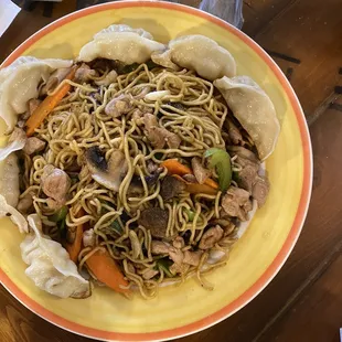 a bowl of noodles with meat and vegetables