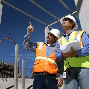 Industrial photography: Engineers reviewing progress in the construction of a Tucson Water water recharge basin in Avra Valley.