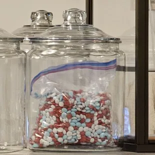 a display of candy in glass jars