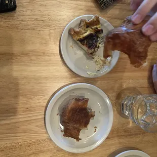 Half eaten chocolate crossaient and a prosciutto quiche