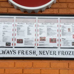 a menu on a brick wall
