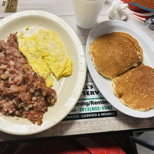 Two eggs and corned beef hash. Pancakes is one of the side options.