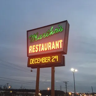 a neon sign for the restaurant