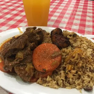 Beef stew over rice and beans with plantains and passion fruit drink