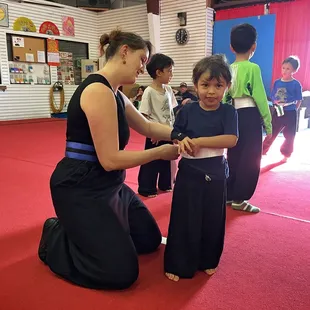 Little Dragons kung fu student Talon earned his white belt by reciting the student creed. Karate for kids helps with self-confidence.