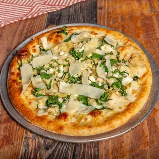 a pizza with cheese and spinach