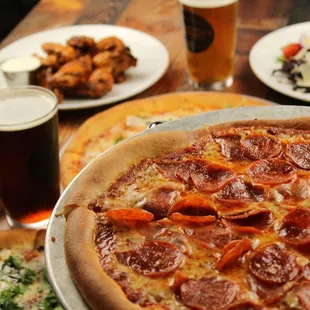 a pizza with pepperoni and a salad