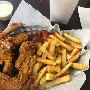 a basket of fried chicken and fries