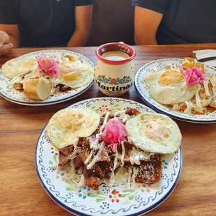Top left to right. Chilaquiles Rancheros, Chilaquiles Divorciados, Chilaquiles Mole Poblano with Café de Olla.