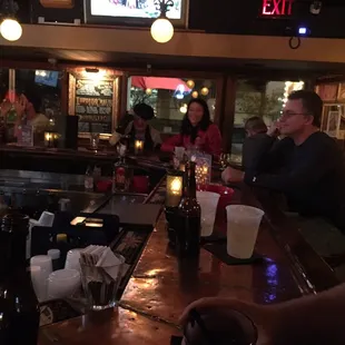 a group of people sitting at a bar