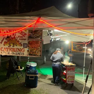 a man cooking food under a tent