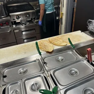 a woman preparing food in a commercial kitchen