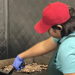 a woman preparing food in a kitchen