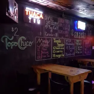 a chalkboard wall with neon signs