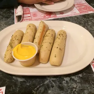Flavorless breadstick with side of nacho cheese.