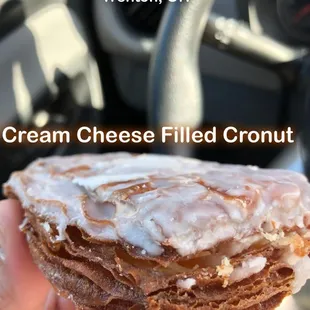 a hand holding a doughnut