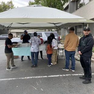 a group of people standing under a tent