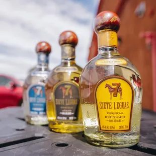 three bottles of tequila on a table