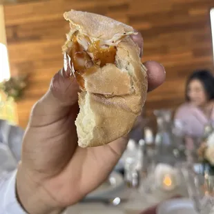 a person holding a sandwich