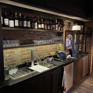 a kitchen with a brick wall