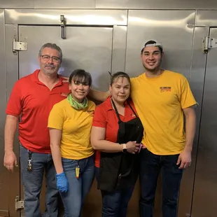 a group of people in a kitchen