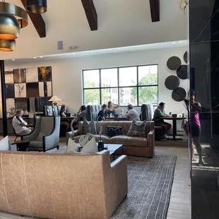 a large living room with couches and tables