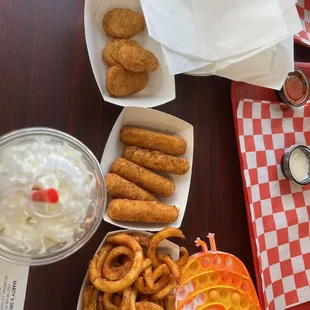 Fruity Pebbles Milkshake with whipped cream, Mozzarella cheese sticks, Onion rings and cheddar cheese jalapeno bombers