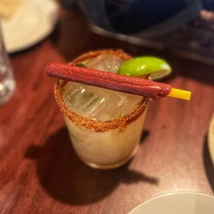 a close up of a drink with a hot stick sticking out of it