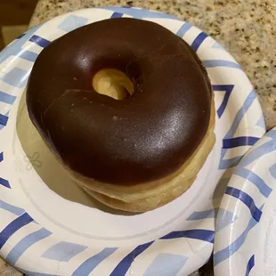 a chocolate frosted donut on a plate