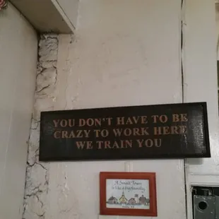 a sign that says you don't have to be crazy to work here we train you