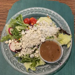 Salad topped with crumbled blue cheese and balsamic vinaigrette