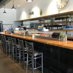 The bar and sushi station with seating.