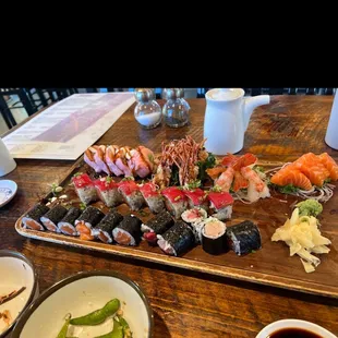 Pink top left is the sushi burrito, sweet shrimp, salmon roll maki, Albacore maki with green onion, tuna maki!