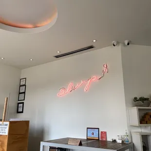 a neon sign above a desk