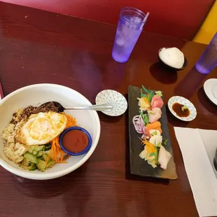 a bowl of sushi with a fried egg on top