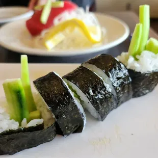 three pieces of sushi on a plate