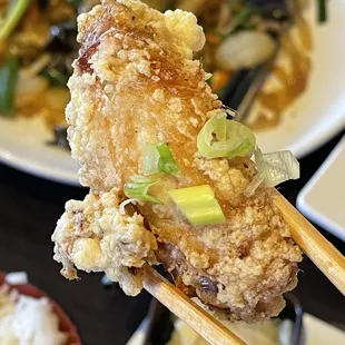 a plate of food with chopsticks