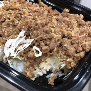 Comes with shredded cabbage layer between the beef and rice
