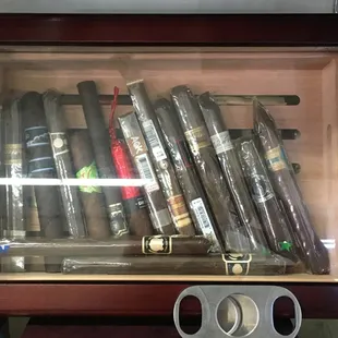cigars and cigar cutters in a display case
