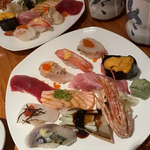 two plates of sushi on a table