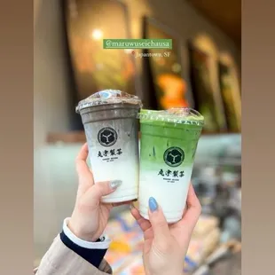 a person holding two cups of coffee