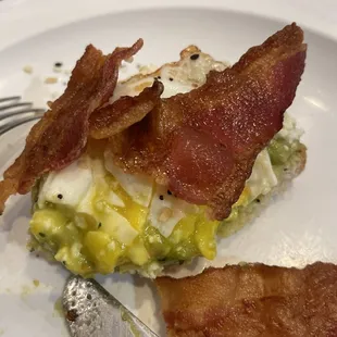 Avocado toast with poached egg and bacon