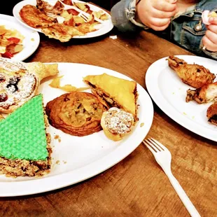 a child eating a variety of pastries