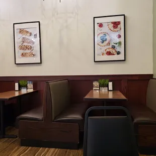 Some booths with pictures of their own food on the walls