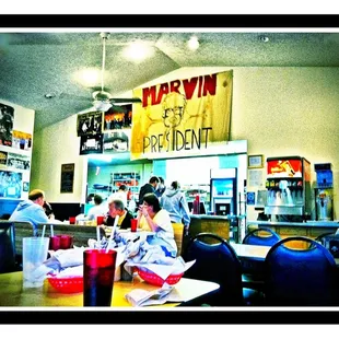 a woman sitting at a table in a restaurant
