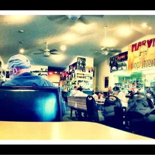 a man sitting at a table in a restaurant