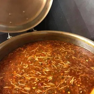 a pot of chili and a pan of cheese