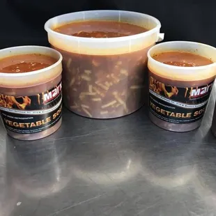 five cups of hot sauce on a table