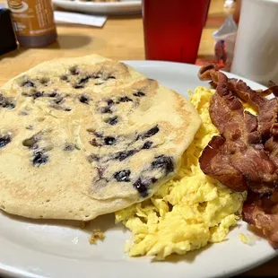 Blueberry pancake, with scrambled eggs and bacon extra crispy